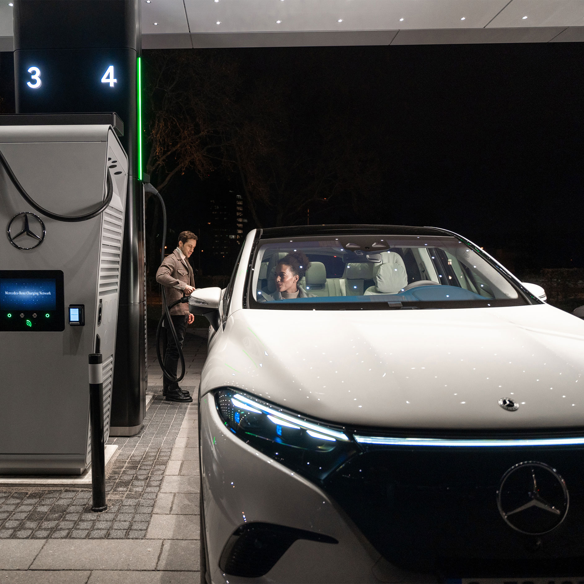 Soluții de încărcare | Tehnologie| Mercedes-Benz Modelul Mercedes-Benz CLA pe o stradă, conectat la o stație de încărcare.