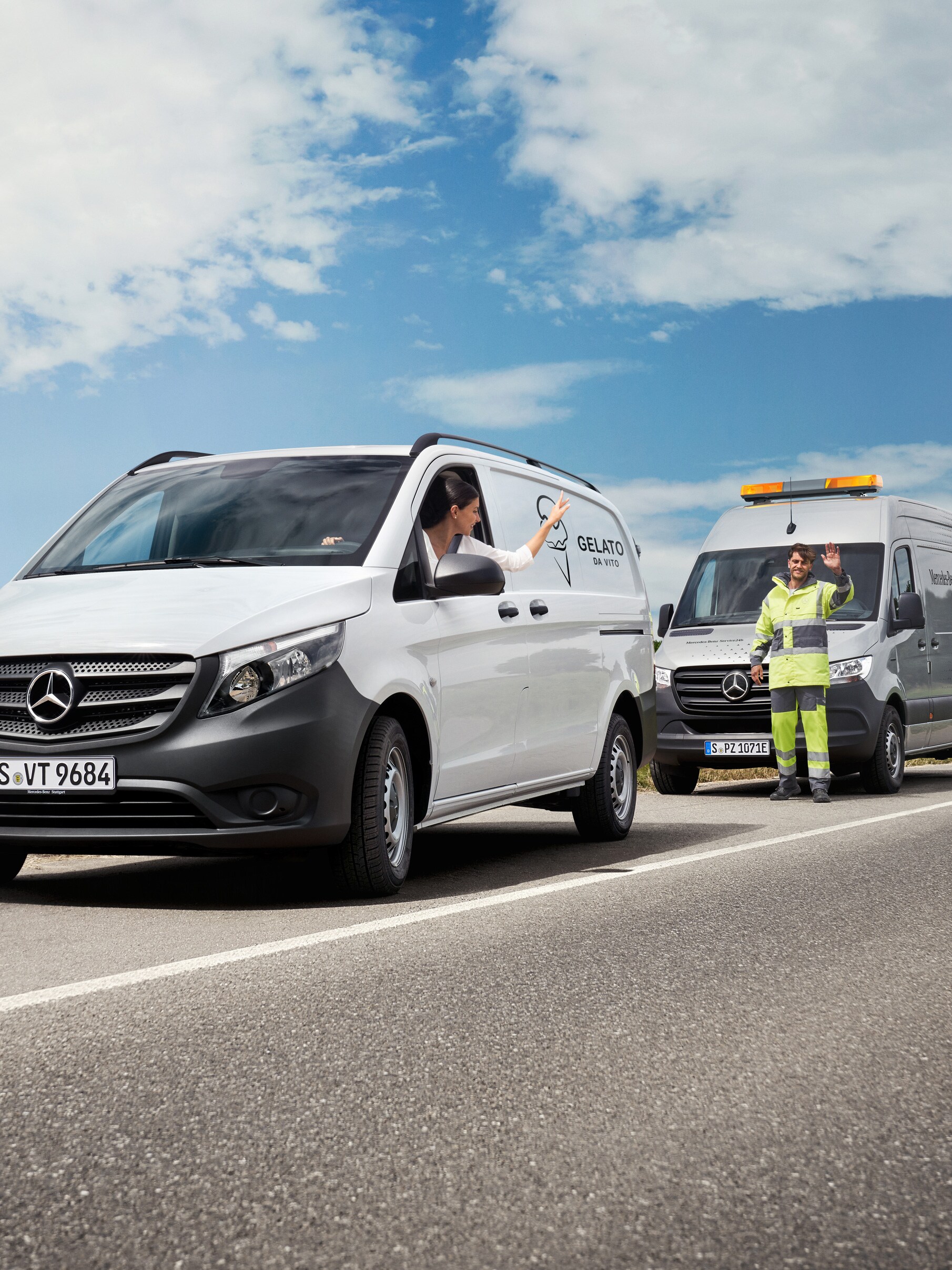O femeie așezată într-un Mercedes-Benz Vito alb face cu mâna unui tehnician de service Mercedes-Benz aflat pe cealaltă parte a drumului.